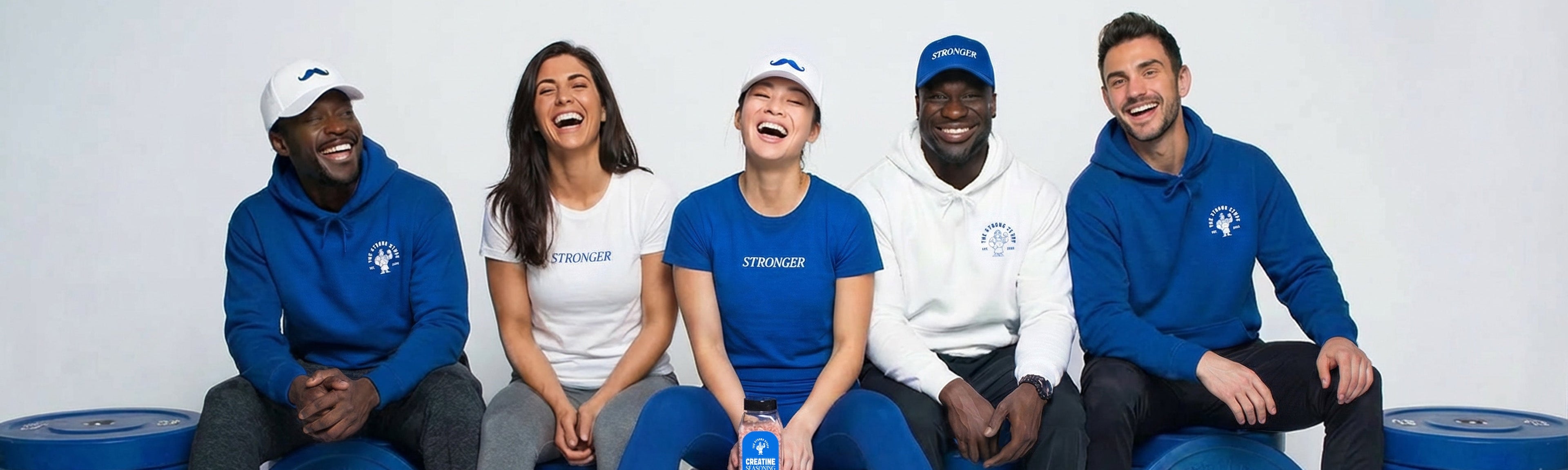 Five people posing with blue weight plates on a white background, with a bottle of creatine